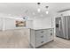 Open floor plan kitchen with island, stainless steel refrigerator, and bright natural light at 1216 Sunland Rd, Daytona Beach, FL 32114