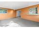 Covered patio featuring light grey concrete floors, orange walls, and white ceiling offers comfortable outdoor space at 1216 Sunland Rd, Daytona Beach, FL 32114