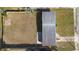 An aerial view shows the layout of the house and its grassy, fenced yard at 1268 Bel Aire Dr, Daytona Beach, FL 32118
