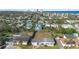 Aerial view of a coastal community showcasing houses, palm trees, and proximity to the ocean at 1268 Bel Aire Dr, Daytona Beach, FL 32118