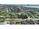 Wide aerial view of a coastal neighborhood, featuring quaint homes, lush trees, and a tranquil waterway backdrop at 1268 Bel Aire Dr, Daytona Beach, FL 32118
