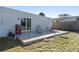 Outdoor patio area with a grill, lounge chair, and a table with chairs, perfect for relaxation at 1268 Bel Aire Dr, Daytona Beach, FL 32118