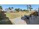 Large, grassy backyard with a patio area featuring outdoor seating and a fenced perimeter at 1268 Bel Aire Dr, Daytona Beach, FL 32118