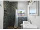 Updated bathroom with a mosaic-tiled shower, pebble flooring, and a stylish vanity at 1268 Bel Aire Dr, Daytona Beach, FL 32118
