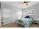 Cozy bedroom with two large windows, wood-look floors, and bright decorative bedding at 1268 Bel Aire Dr, Daytona Beach, FL 32118