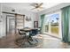 Bright dining area featuring a ceiling fan, a view to the street, and modern decor at 1268 Bel Aire Dr, Daytona Beach, FL 32118