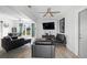 Well-lit living room with ceiling fan, wood-look tile flooring, and a sliding glass door for natural light at 1268 Bel Aire Dr, Daytona Beach, FL 32118