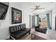 Cozy living room with ceiling fan, wood-look tile flooring, and a sliding glass door to the backyard at 1268 Bel Aire Dr, Daytona Beach, FL 32118