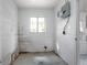 Empty utility room featuring concrete block walls, window, and an electrical panel at 137 Lucerne Dr, Debary, FL 32713