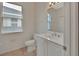 Bright bathroom featuring white vanity, toilet, mirror, and tiled floor at 1429 Carlow Cir, Ormond Beach, FL 32174