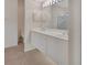 Bright bathroom featuring double sinks, white cabinets, tile floors, and an adjoining shower at 1429 Carlow Cir, Ormond Beach, FL 32174