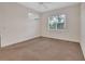 Neutral bedroom with carpet, a ceiling fan, and a bright window at 1429 Carlow Cir, Ormond Beach, FL 32174