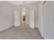 Neutral bedroom with carpet and an open door leading to the kitchen at 1429 Carlow Cir, Ormond Beach, FL 32174