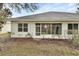 Exterior view of home featuring screen enclosed lanai and shuttered windows at 1429 Carlow Cir, Ormond Beach, FL 32174
