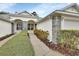Inviting home exterior with stone accents, landscaped walkway, and charming facade at 1429 Carlow Cir, Ormond Beach, FL 32174