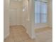 Bright tiled foyer featuring white walls and a glass-paneled door at 1429 Carlow Cir, Ormond Beach, FL 32174
