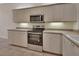 Bright kitchen with stainless steel appliances, tiled floors, and light countertops at 1429 Carlow Cir, Ormond Beach, FL 32174