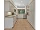 Bright kitchen with stainless steel appliances, tiled floors, and light countertops at 1429 Carlow Cir, Ormond Beach, FL 32174