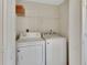 Functional laundry room with washer, dryer, and shelving unit at 1429 Carlow Cir, Ormond Beach, FL 32174