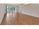 Bright living room with beautiful wood floors and large sliding glass doors to the lanai at 1429 Carlow Cir, Ormond Beach, FL 32174