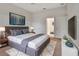 Staged main bedroom with a ceiling fan, king bed, en suite, and modern decor at 1429 Carlow Cir, Ormond Beach, FL 32174