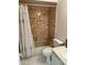 Bathroom featuring tile walls, bathtub with shower, toilet, and sink, ready for relaxation at 168 Olive Tree Cir # 168, Altamonte Springs, FL 32714