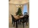 Inviting dining room with a wooden table, seating for four, and a chandelier with an adjacent tree at 168 Olive Tree Cir # 168, Altamonte Springs, FL 32714