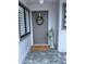 Welcoming front entrance features a gray door with a wreath and a 'Welcome' doormat at 168 Olive Tree Cir # 168, Altamonte Springs, FL 32714