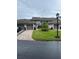 Charming townhouse with attached garages and well-maintained front yard landscaping on a cloudy day at 168 Olive Tree Cir # 168, Altamonte Springs, FL 32714