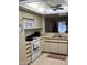 Functional kitchen with white appliances, tile floors and a cozy breakfast nook visible through the pass-through at 168 Olive Tree Cir # 168, Altamonte Springs, FL 32714