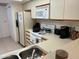 Efficient kitchen layout featuring bright countertops, tile flooring, and essential appliances for everyday cooking at 168 Olive Tree Cir # 168, Altamonte Springs, FL 32714