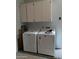 Laundry room with white washer and dryer and white overhead cabinets at 168 Olive Tree Cir # 168, Altamonte Springs, FL 32714