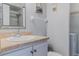 Bathroom vanity with faucet, framed mirror, towel rack and toilet; washer and dryer visible in adjacent closet at 179 Moonstone Ct, Port Orange, FL 32129