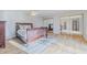 Light-filled bedroom with hardwood floors, large mirrored closet, and neutral decor at 179 Moonstone Ct, Port Orange, FL 32129