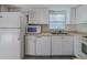 Charming kitchen featuring white appliances, cabinets and sleek countertops at 179 Moonstone Ct, Port Orange, FL 32129