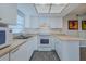 Bright kitchen with white cabinetry, laminate countertops and modern appliances at 179 Moonstone Ct, Port Orange, FL 32129