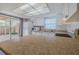 Bright kitchen features white cabinetry, stainless steel appliances, and sliding glass doors to the outdoor area at 179 Moonstone Ct, Port Orange, FL 32129