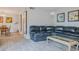 Spacious living room with gray flooring, a large black couch, and modern decor at 179 Moonstone Ct, Port Orange, FL 32129