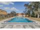 Community pool with lounge chairs and clear blue water on a sunny day at 179 Moonstone Ct, Port Orange, FL 32129