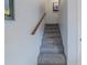Carpeted interior stairway with wooden handrail at 179 Moonstone Ct, Port Orange, FL 32129