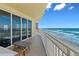 Balcony with outdoor seating and slider doors open to ocean views at 1900 N Atlantic Ave # 901, Daytona Beach, FL 32118