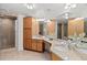 Bathroom with double vanity sinks, granite countertops, lots of cabinets, and a separate glass shower at 1900 N Atlantic Ave # 901, Daytona Beach, FL 32118