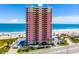 Stunning beachfront condominium with ocean views, a pool, a parking area, and tropical landscaping at 1900 N Atlantic Ave # 901, Daytona Beach, FL 32118