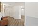 Hallway featuring wood flooring, a leather bench, white walls, and decorative wall lighting at 1900 N Atlantic Ave # 901, Daytona Beach, FL 32118