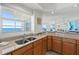 Modern kitchen with stainless steel sink, granite countertops, and scenic ocean view from the window at 1900 N Atlantic Ave # 901, Daytona Beach, FL 32118