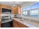 Well-lit kitchen with stainless steel appliances, granite countertops and a window overlooking the city and ocean at 1900 N Atlantic Ave # 901, Daytona Beach, FL 32118
