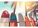 Colorful surfboards lined up by the beach with palm trees in the background create a tropical vacation vibe at 1900 N Atlantic Ave # 901, Daytona Beach, FL 32118