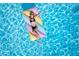 Top view of Personal relaxing in the pool on floaties at 1900 N Atlantic Ave # 901, Daytona Beach, FL 32118
