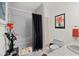 A full bathroom, featuring a shower with grey tiling and black curtain and white sink at 1924 Seclusion Dr, Port Orange, FL 32128