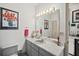 Neutral-toned bathroom with a marble countertop, under-mount sink, and unique decorations at 1924 Seclusion Dr, Port Orange, FL 32128